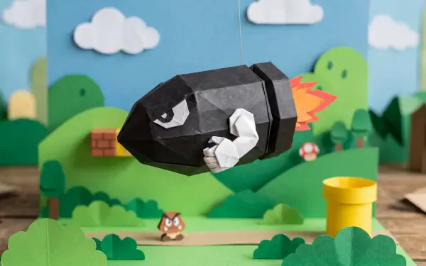 Papercraft Bullet Bill soaring over a colorful Mario-style papercraft landscape — 5K Ultra HD PC desktop wallpaper and background.