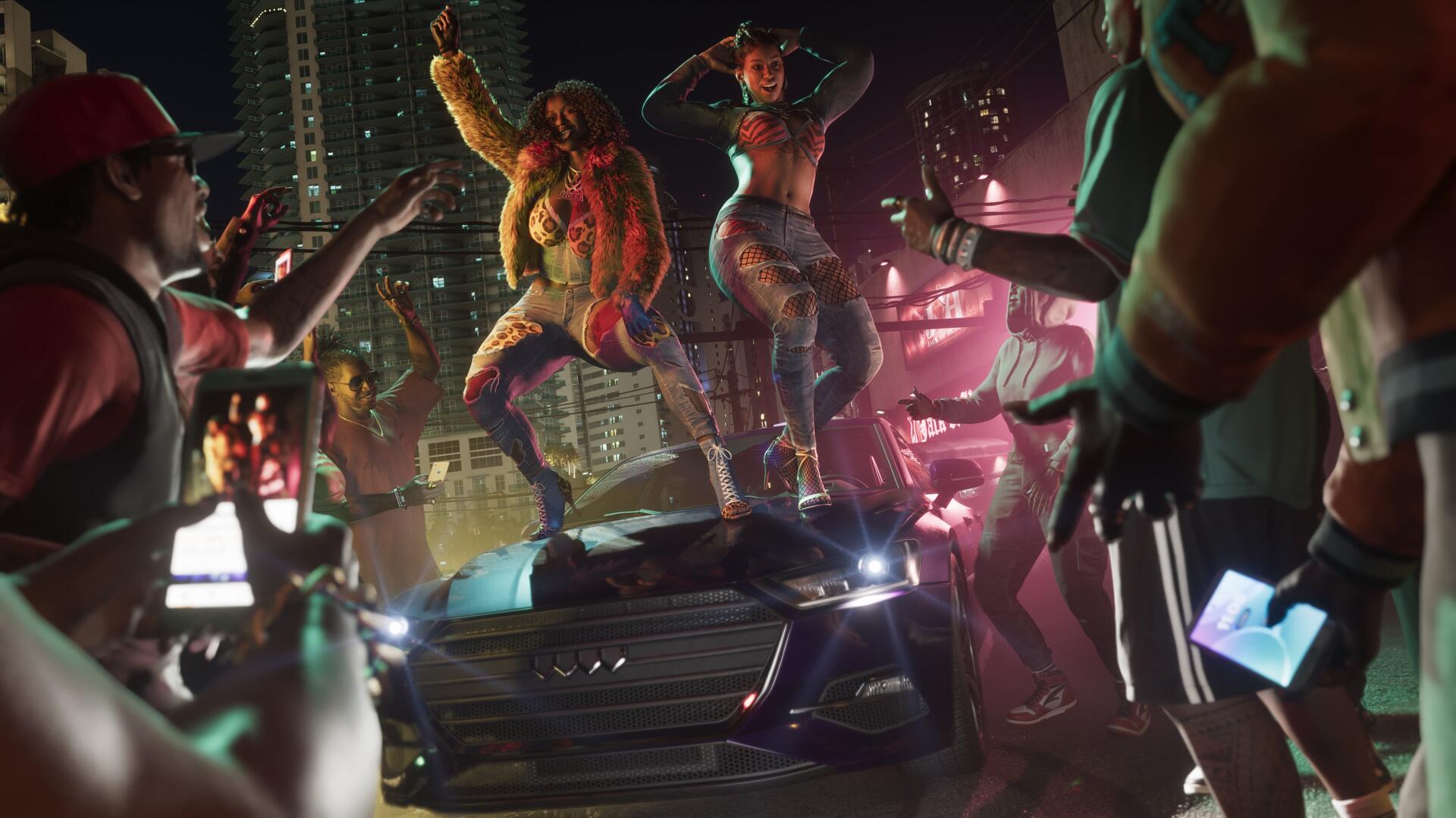 4K Ultra HD PC desktop wallpaper: Grand Theft Auto VI video game scene by Real Dimez — two dancers on a car hood amid neon city chaos as onlookers film with phones.