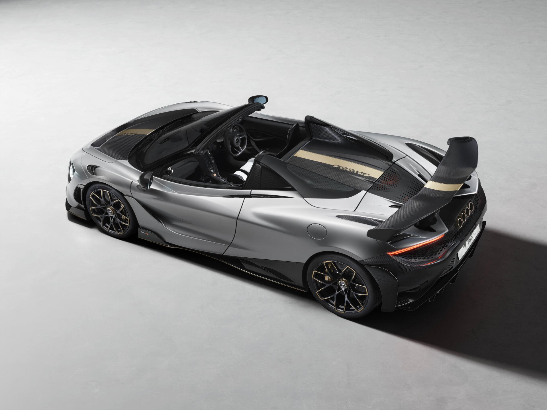8K Ultra HD PC desktop wallpaper background of a silver McLaren 788HS sports car, rear three-quarter view highlighting aerodynamic lines and prominent rear wing.
