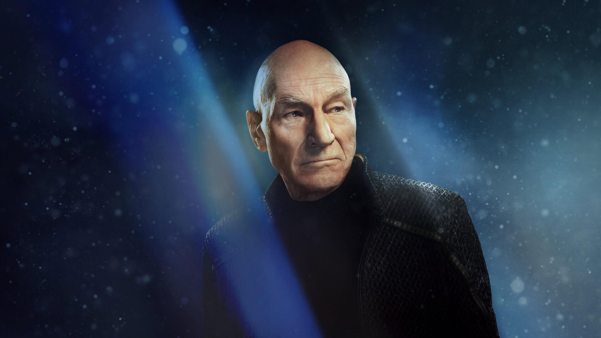 Star Trek: Picard 4K Ultra HD PC desktop wallpaper — brooding bald Starfleet captain in black uniform gazes through blue starlit nebula.