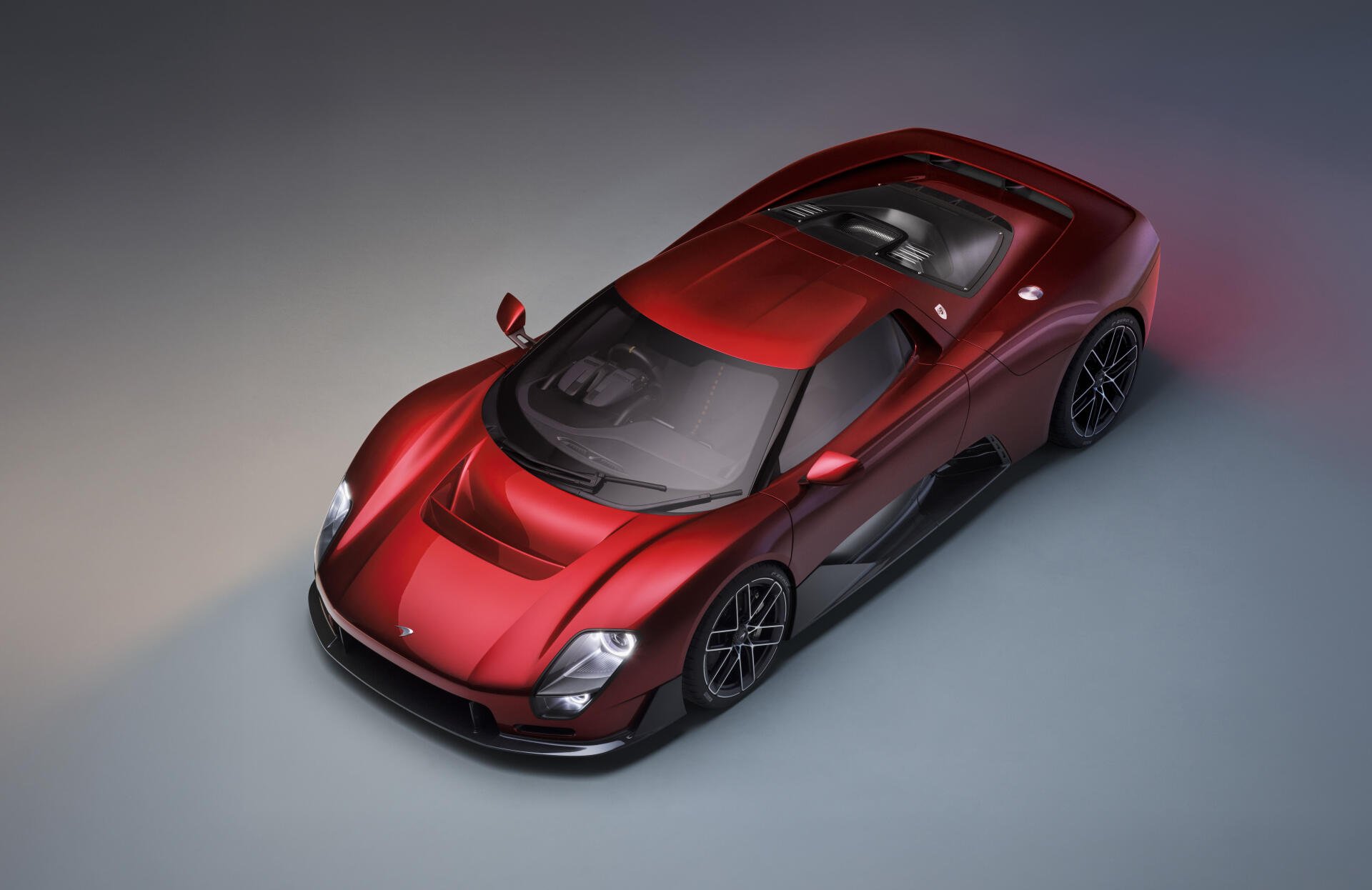 Top-down view of a red McLaren McL 6GT sports car in 8K Ultra HD, rendered as a PC desktop wallpaper and background.