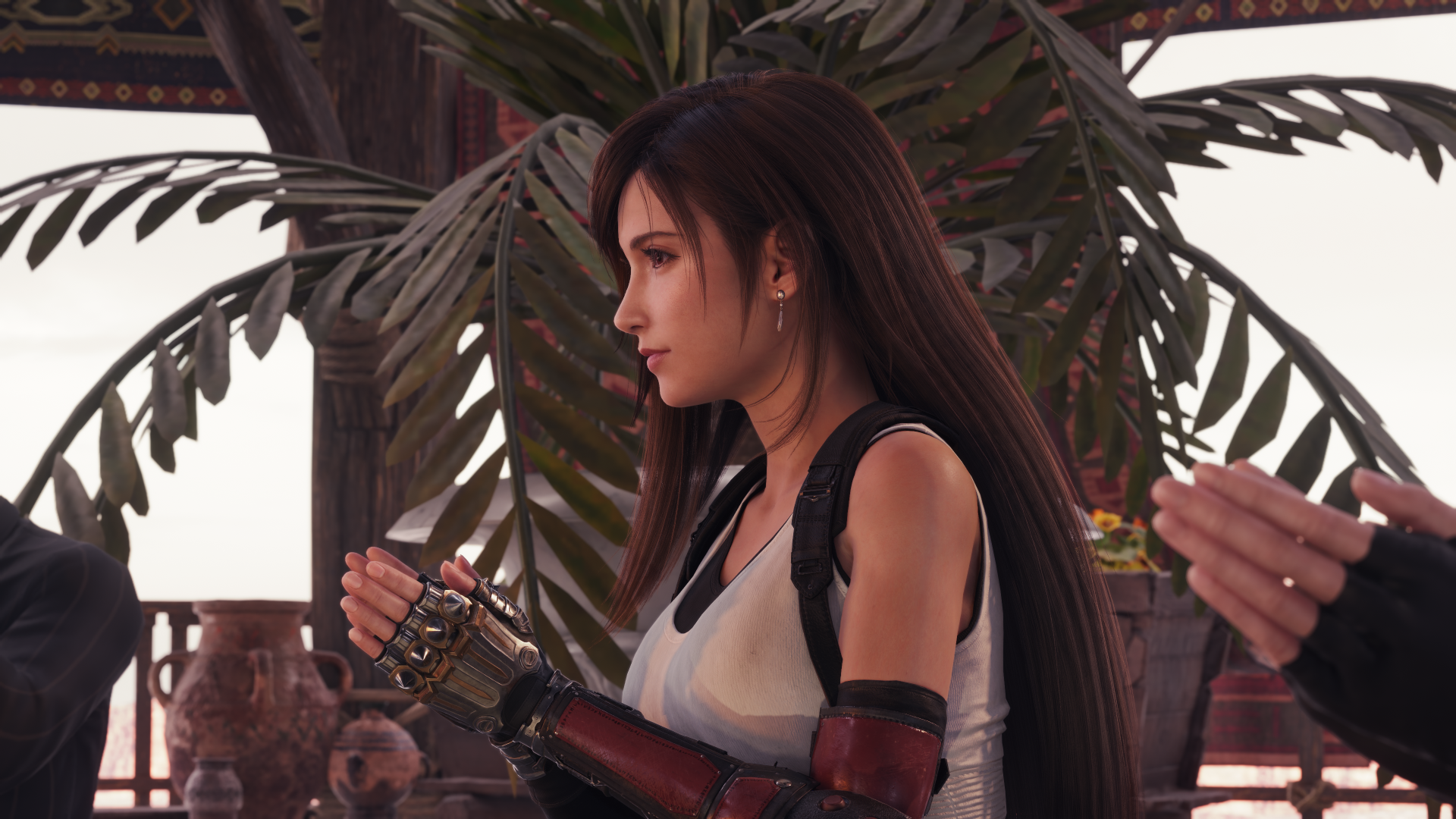Side profile of Tifa Lockhart from Final Fantasy VII Rebirth, hands clasped, wearing white tank top and gauntlets, tropical foliage behind — 4K Ultra HD PC desktop wallpaper/background.