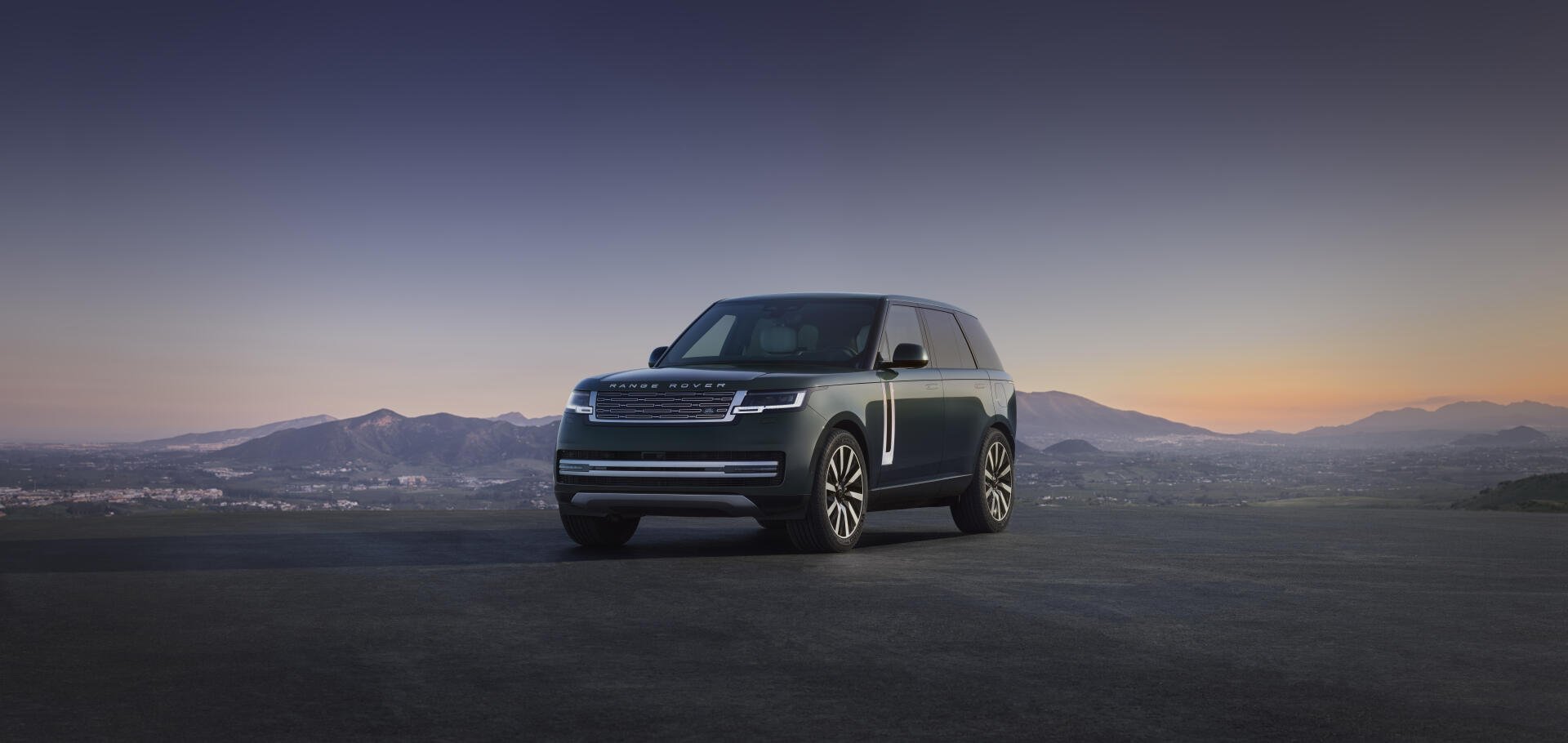 Range Rover Electric SUV car on an open plain at dusk, shown as an 8K Ultra HD PC desktop wallpaper and background.