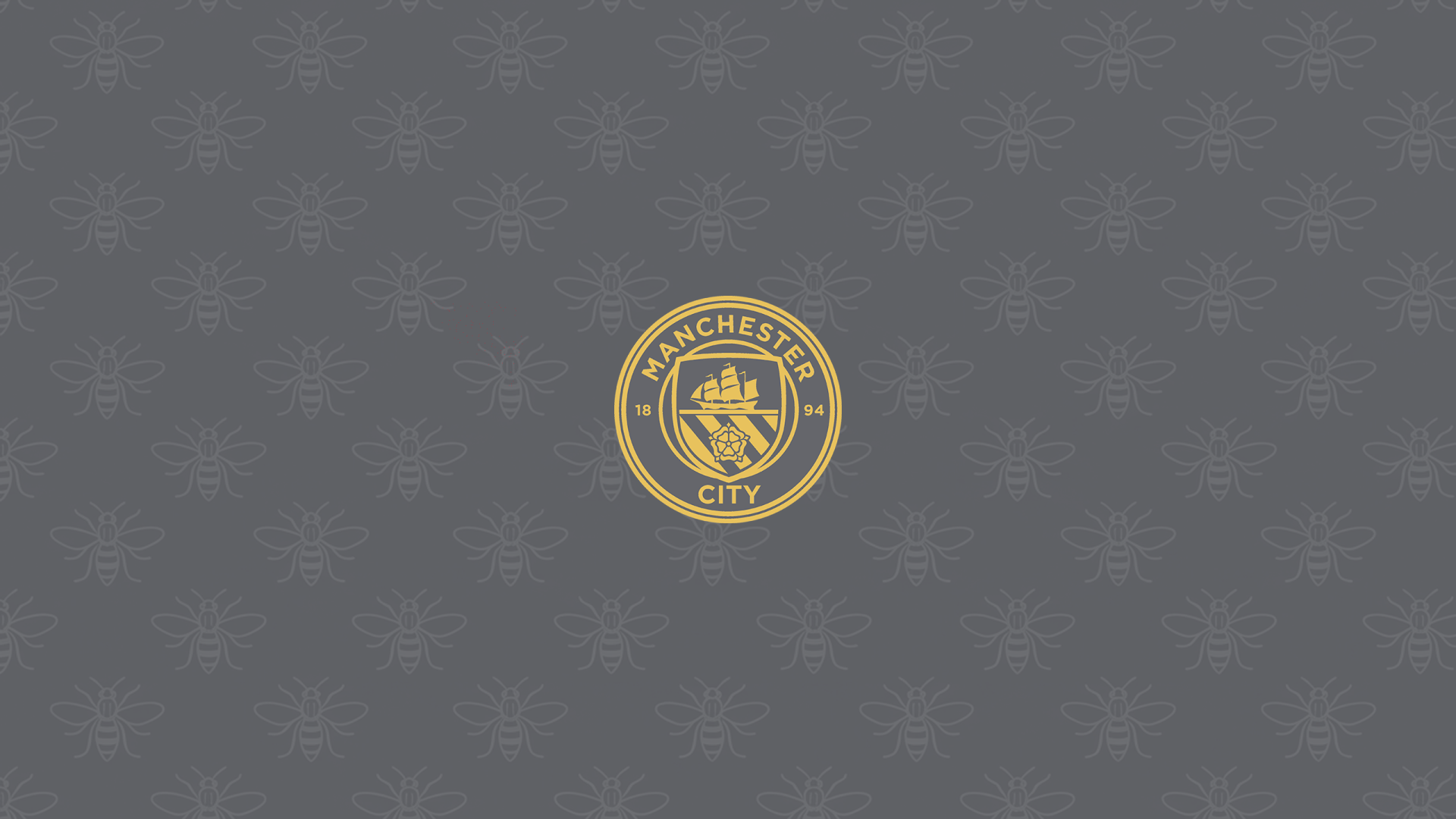 Manchester City F.C. gold crest centered on a textured gray 2K Quad HD PC desktop wallpaper background.
