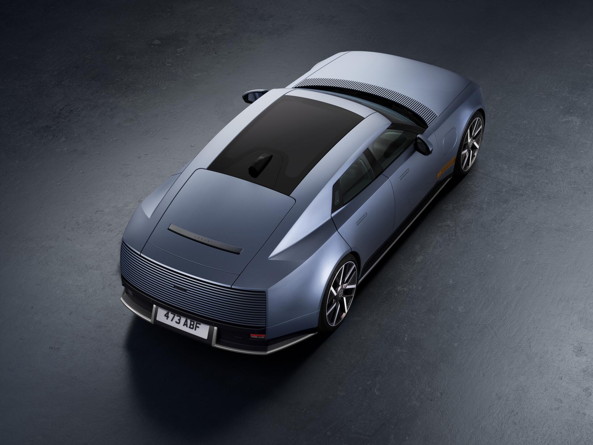 Jaguar Type 01 electric sedan in an 8K Ultra HD desktop wallpaper, viewed from above.