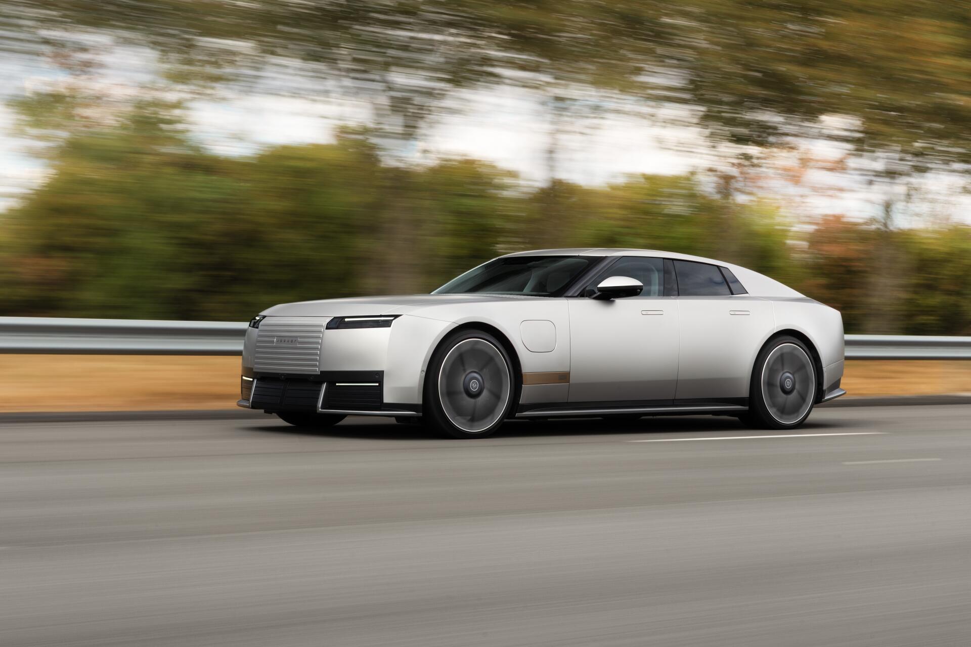Jaguar Type 01 luxury coupé speeding along a road in a 5K Ultra HD PC desktop wallpaper background.