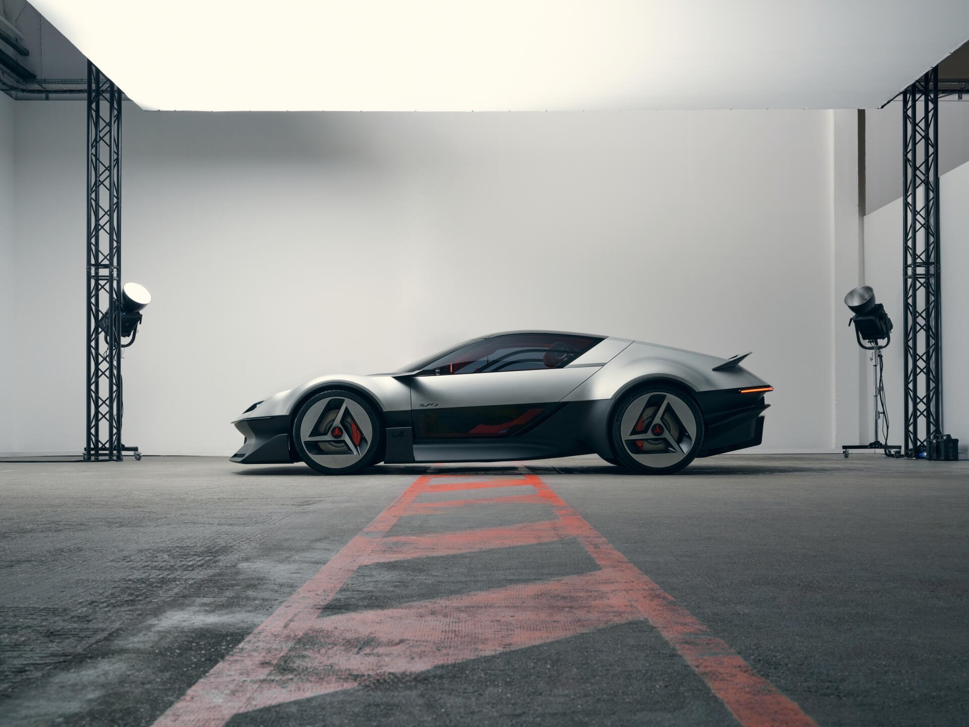 Alpine A310 Vision concept sports car in a modern studio, featured in a 5K Ultra HD desktop wallpaper and background.