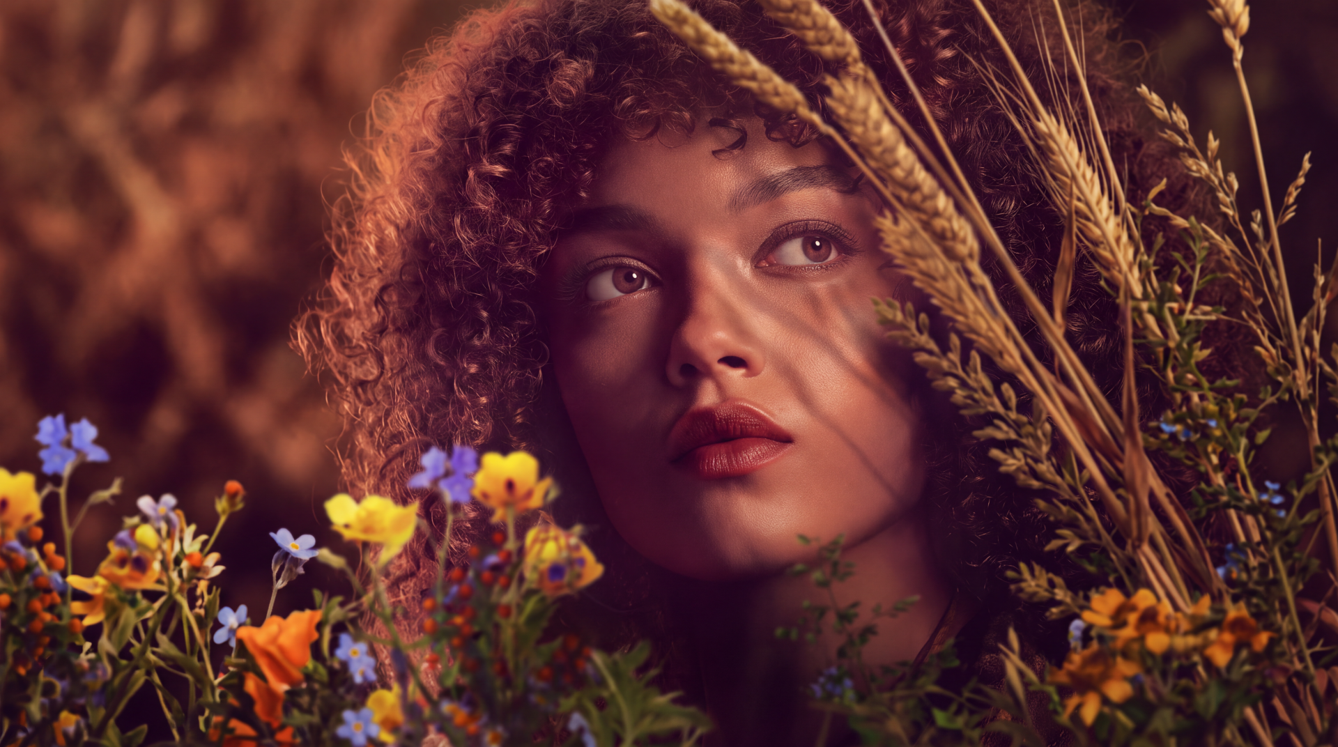 Lenore Dove from The Hunger Games in a flower-framed portrait, featured in a warm, cinematic 5K Ultra HD desktop wallpaper.