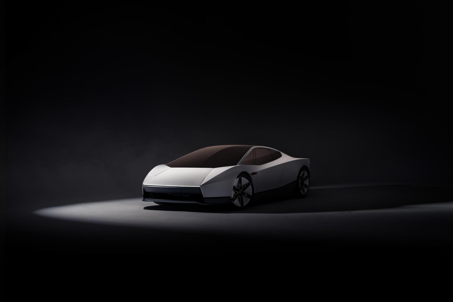 Tesla Roadster electric concept car in a dark studio, featured in a 2K Quad HD PC desktop wallpaper and background.