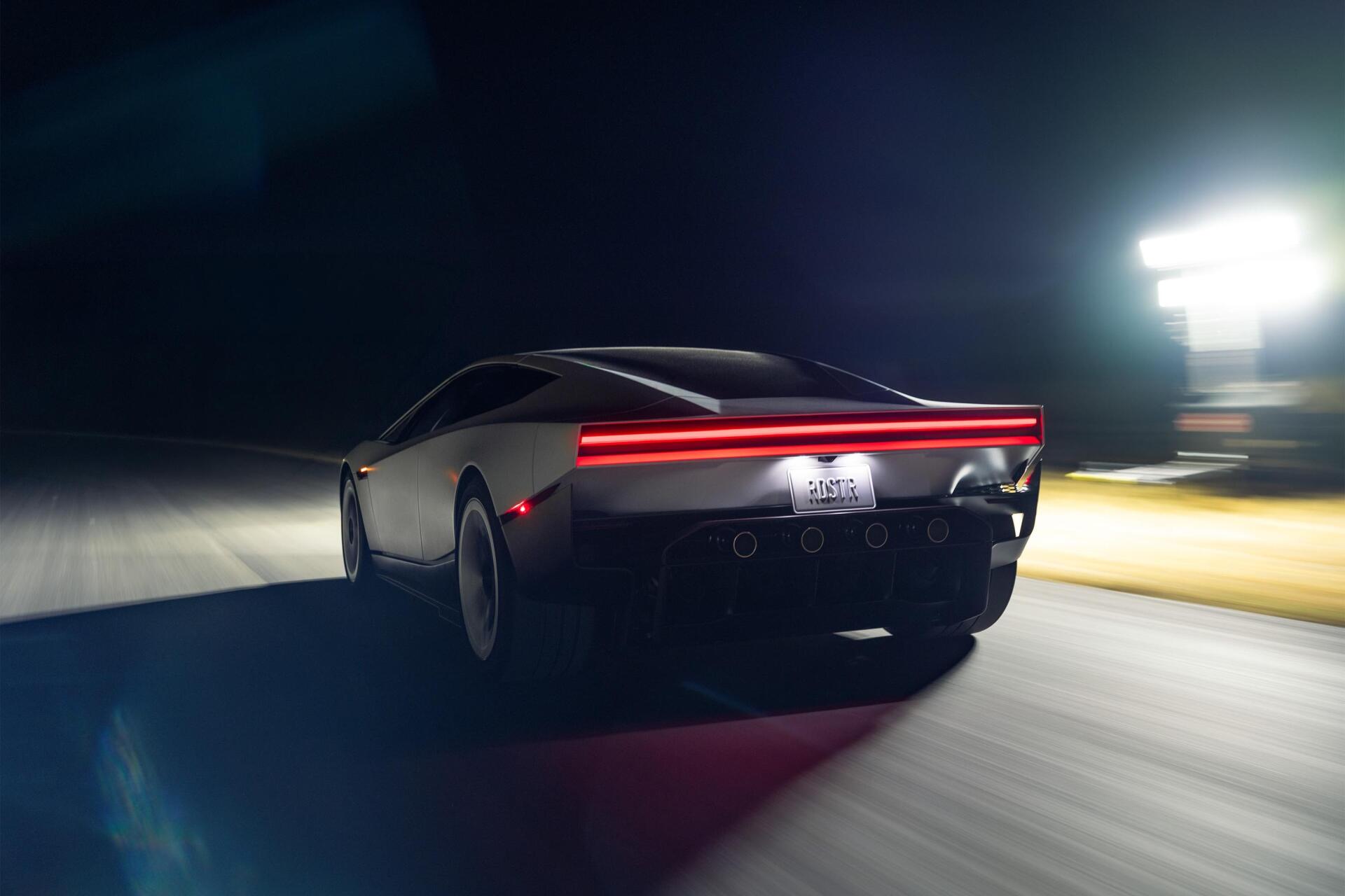 Tesla Roadster electric sports car speeding at night, shown in a cinematic 2K Quad HD desktop wallpaper.
