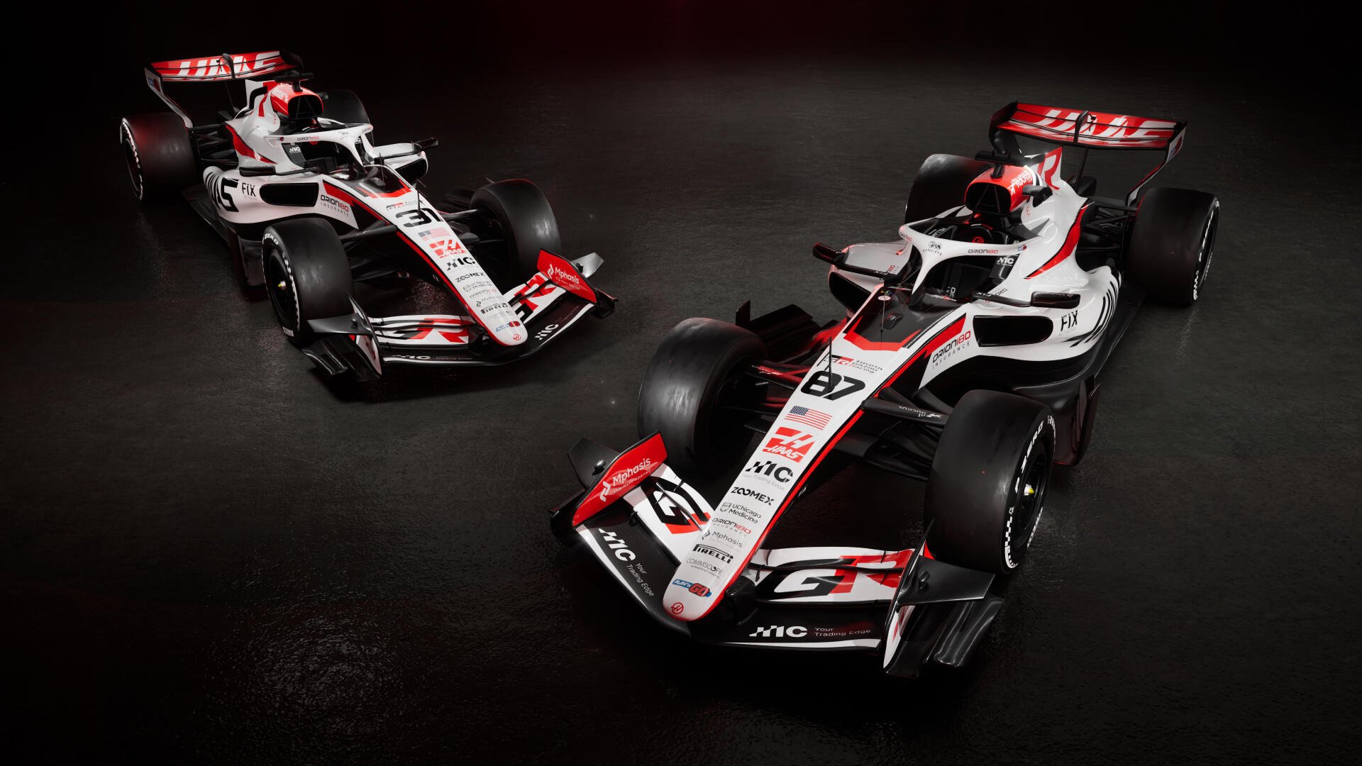 Haas F1 Team VF-26 race cars in a dramatic studio scene, featured in a 4K Ultra HD PC desktop wallpaper.