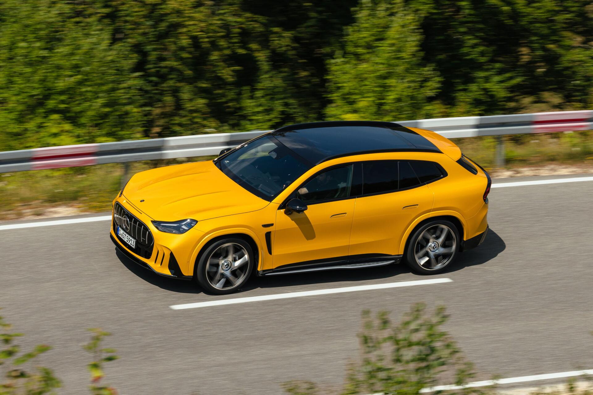 Yellow Mercedes-AMG GT SUV driving on a forest road, 2K Quad HD desktop wallpaper featuring a Mercedes-Benz performance car.