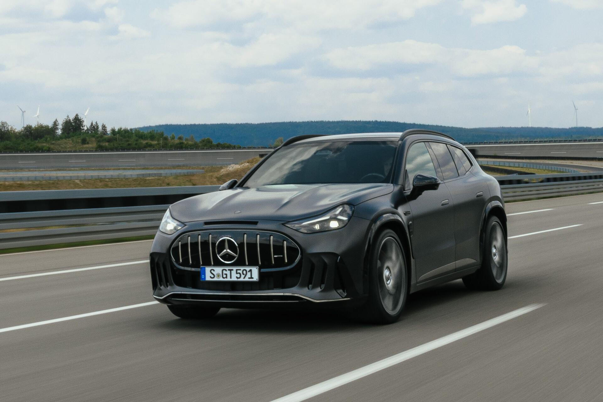Mercedes-AMG GT SUV driving on a highway, 2K Quad HD PC desktop wallpaper featuring a sleek Mercedes-Benz car.