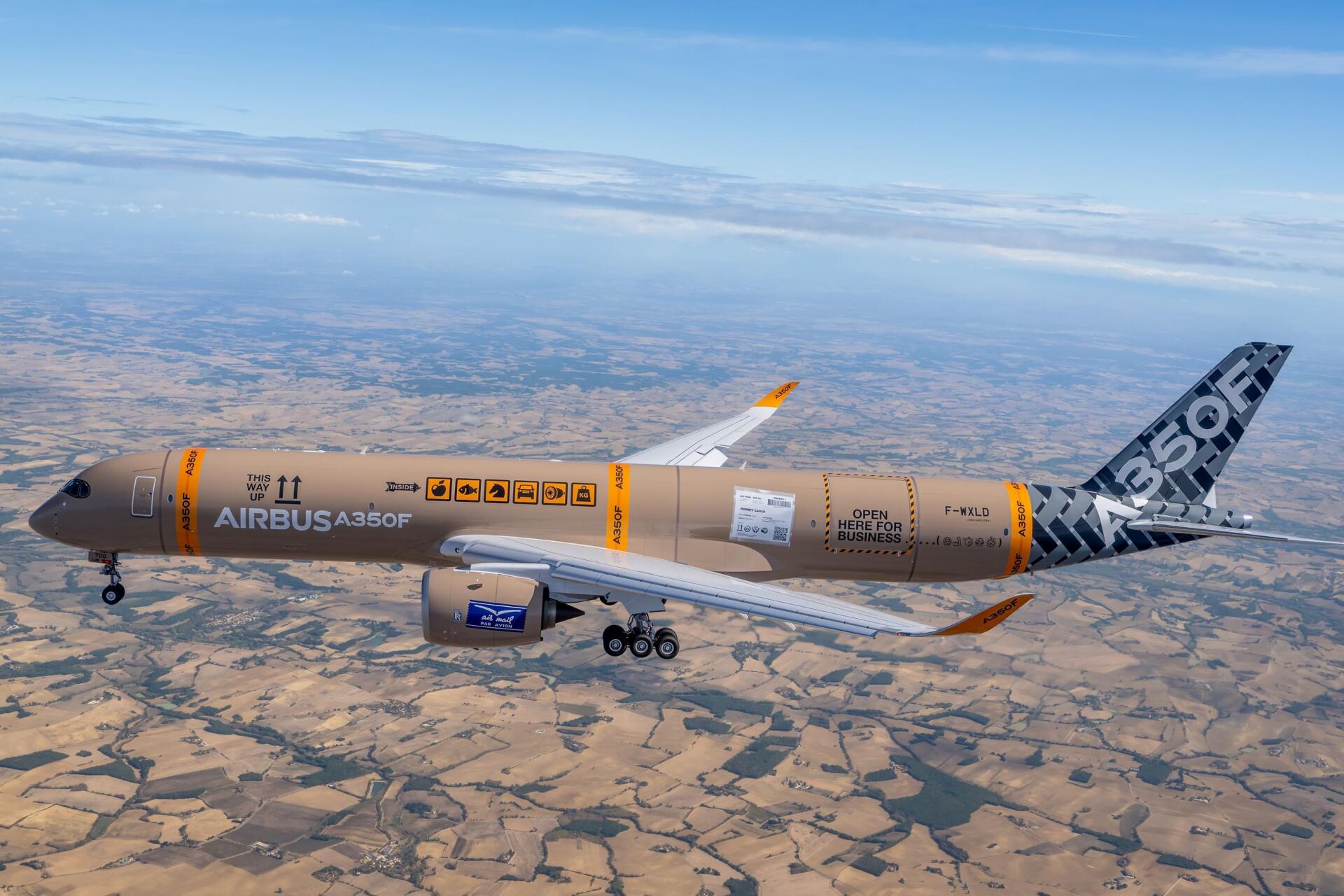 Airbus A350F cargo airplane flying over dry terrain, featured in a 2K Quad HD PC desktop wallpaper and background.
