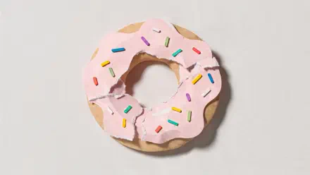 4K Ultra HD PC desktop wallpaper showing a pink-frosted doughnut with rainbow sprinkles on a pale background.