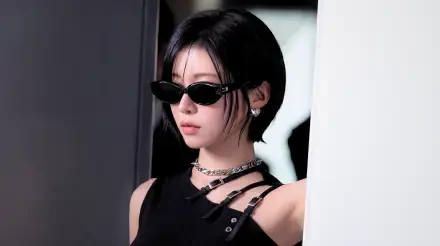 5K Ultra HD wallpaper: k-pop idol–styled Japanese model in sleek black The Matrix–inspired outfit with narrow sunglasses, cool moody studio background.