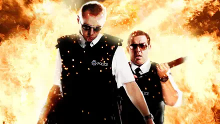 Hot Fuzz 4K Ultra HD PC wallpaper: two uniformed police officers in vests stride forward as a fiery explosion erupts behind them.