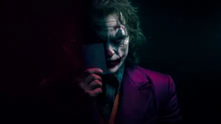 4K Ultra HD PC wallpaper of the Joker in film-inspired makeup and purple suit, holding a mask that hides half his face, moody shadows and dramatic lighting.