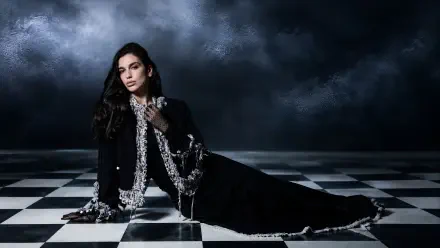 Moody portrait of a female singer in a black gown on a checkerboard floor beneath stormy clouds — music-themed 4K Ultra HD PC desktop wallpaper/background.