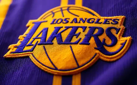 Close-up embroidered Los Angeles Lakers NBA logo on purple and gold fabric; 4K Ultra HD PC desktop wallpaper background.