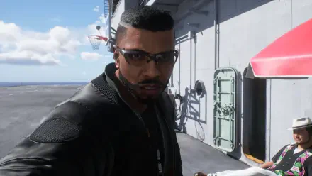 Ace Combat 8: Wings of Theve HD PC desktop wallpaper: close-up of a man with close-cropped hair and sunglasses in a tactical jacket standing on an aircraft carrier deck under blue sky.