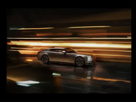 Jaguar Type 01 luxury sedan speeding through city lights at night, 8K Ultra HD PC desktop wallpaper and background.