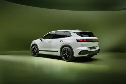 White Volkswagen ID. Tiguan electric SUV in a green studio, featured in a 4K Ultra HD PC desktop wallpaper background.