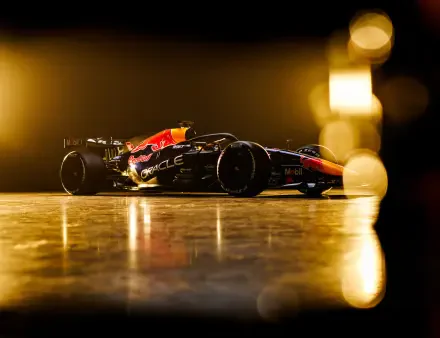 Red Bull Racing RB22 F1 race car speeding through a golden-lit track, 4K Ultra HD PC desktop wallpaper and background.