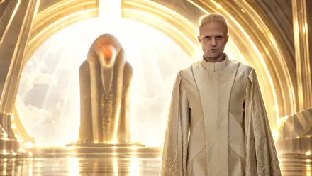 Robert Pattinson in cream robes before a glowing sci-fi monument in Dune: Part Three, 4K Ultra HD PC desktop wallpaper and background.
