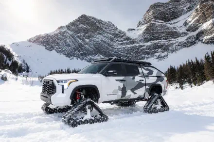 Toyota Tundra Snowhunter with snow tracks in a snowy mountain landscape, 2K Quad HD PC desktop wallpaper and background.