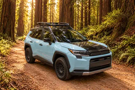 Toyota RAV4 Woodland Concept SUV parked on a forest trail, shown in a 2K Quad HD PC desktop wallpaper.