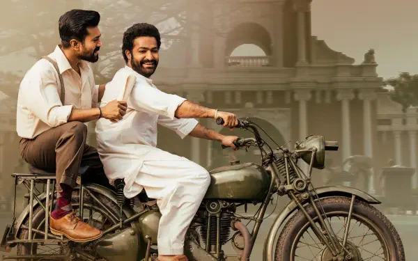 RRR 4K Ultra HD PC Desktop Wallpaper and Background: two smiling men on a vintage motorcycle riding past a stately colonial-style building.