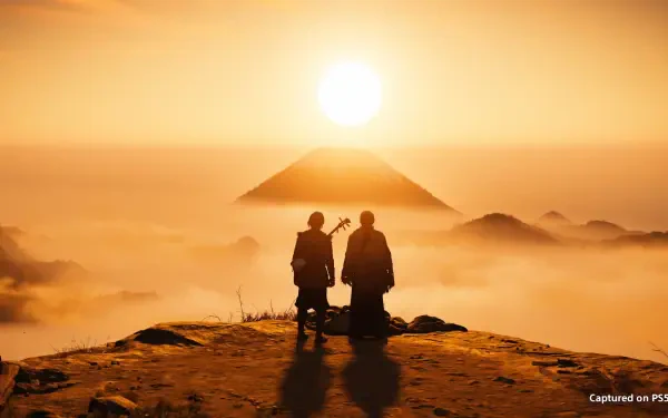 HD PC desktop wallpaper of two silhouetted figures from the video game Ghost of Yōtei on a mountain ridge at sunrise, misty peaks and a pyramid-like Yōtei glowing in golden light.