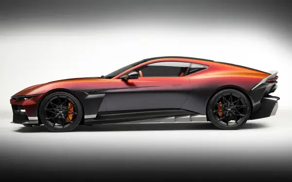 2K Quad HD desktop wallpaper: side view of an orange-gray Aston Martin Valen coupé sports car on a soft white vignette backdrop.