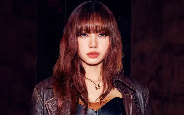5K desktop wallpaper: close-up portrait of a brunette with bangs in a leather jacket and necklace, K-pop style, moody dark background.