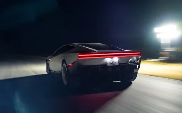 Tesla Roadster electric sports car speeding at night, shown in a cinematic 2K Quad HD desktop wallpaper.