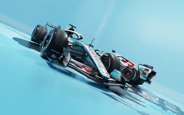 Haas F1 Team VF-26 race car speeding across a blue track, HD desktop wallpaper and background.