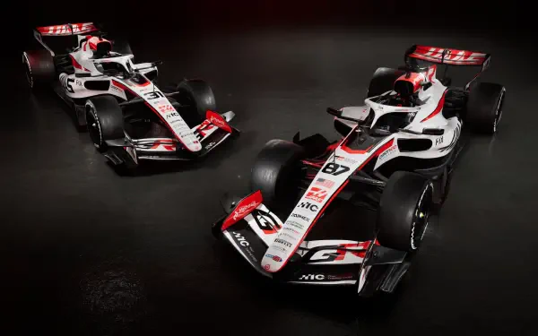 Haas F1 Team VF-26 race cars in a dramatic studio scene, featured in a 4K Ultra HD PC desktop wallpaper.