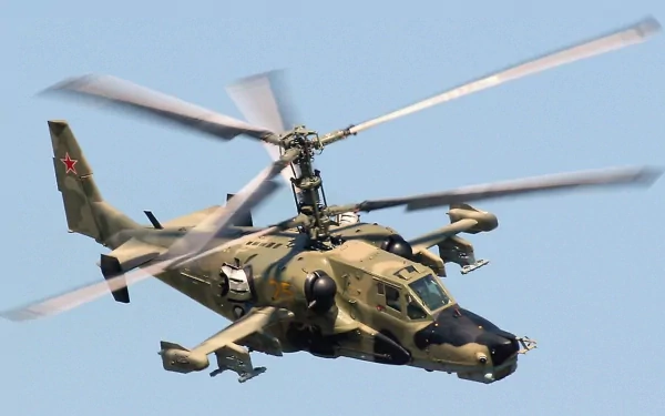 HD desktop wallpaper featuring the military Kamov Ka-50 attack helicopter in flight against a clear blue sky.