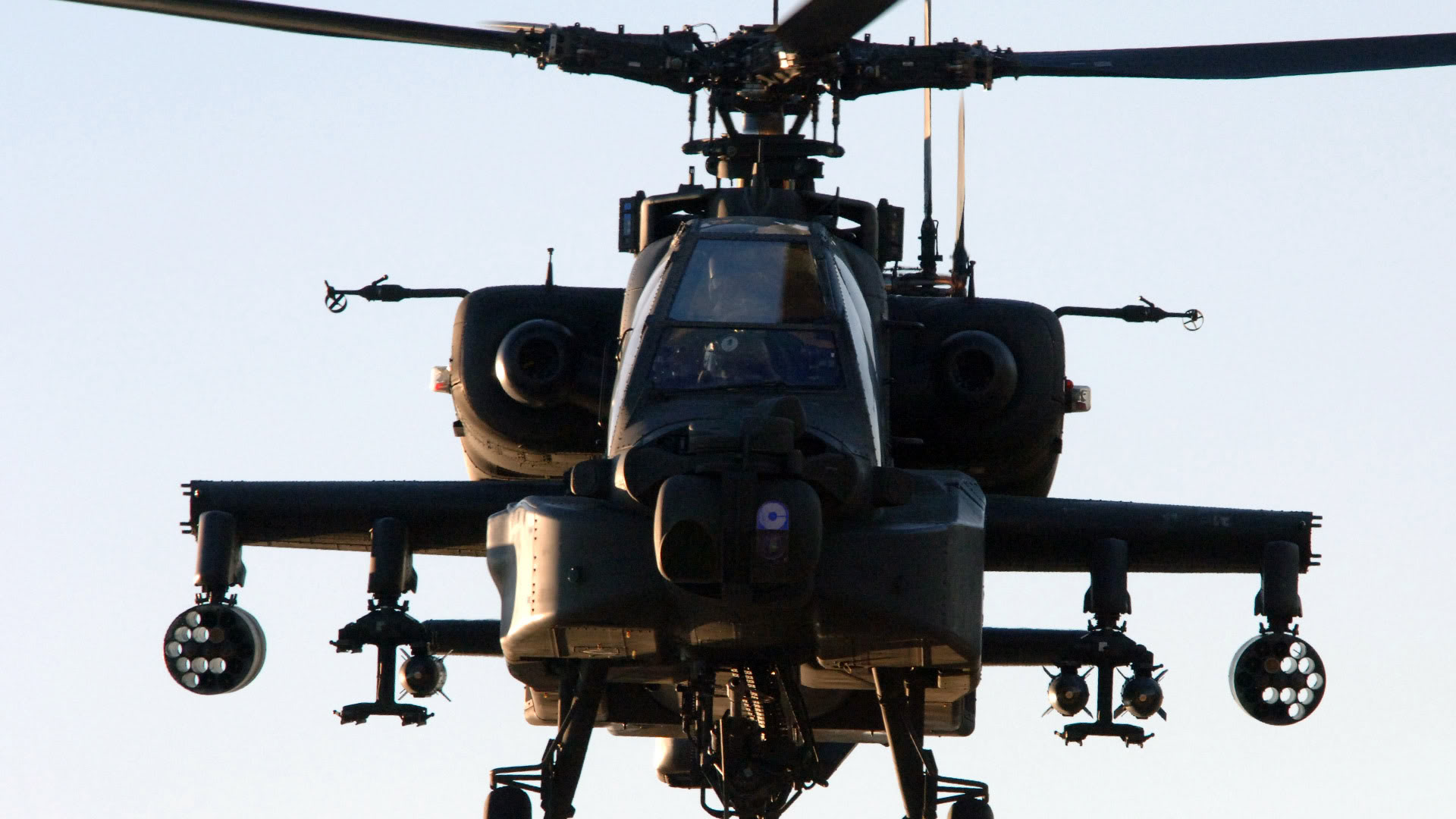 A powerful Boeing AH-64 Apache military helicopter soaring through the sky.