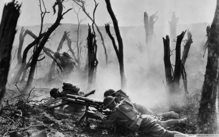 Black and white World War I military scene showing soldiers operating a machine gun amidst barren, war-torn trees and thick smoke, captured in HD quality.