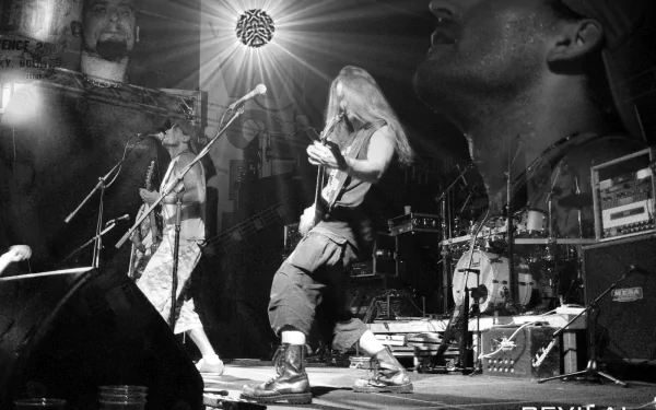 Black and white HD desktop wallpaper of Sepultura performing live on stage, featuring dynamic band members and intense lighting capturing the energy of their music.