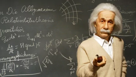 HD desktop wallpaper featuring Albert Einstein standing in front of a chalkboard filled with scientific equations, holding a pipe. The background embodies a sense of scientific inquiry and genius.