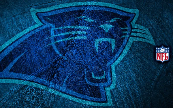 HD PC desktop wallpaper featuring the Carolina Panthers logo with a textured blue background and a small NFL emblem on the right side.