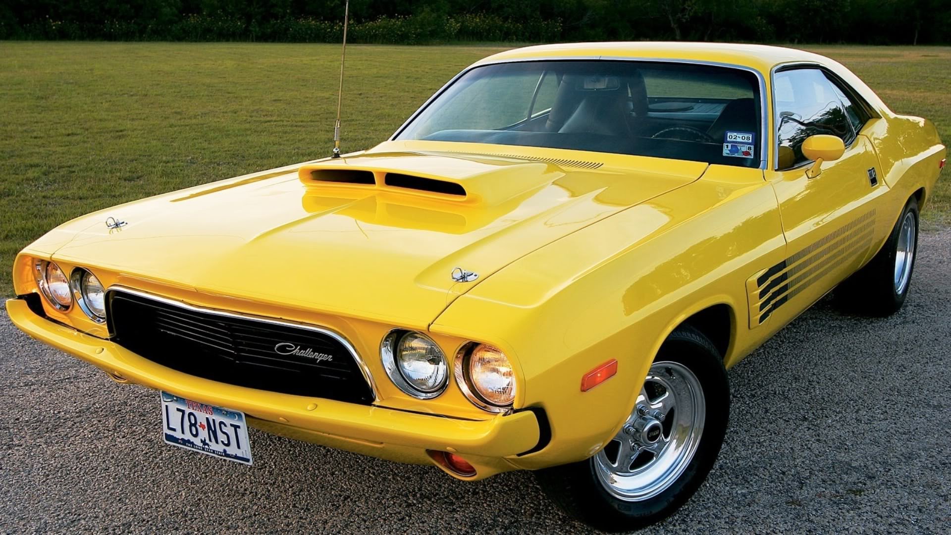 HD desktop wallpaper featuring a bright yellow Dodge vehicle parked on a paved surface with grass in the background.