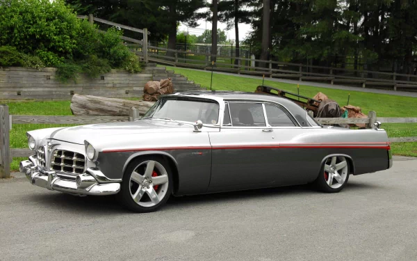 4K Ultra HD desktop wallpaper featuring a classic Chrysler vehicle in a driveway with a rustic wooden fence and greenery in the background.