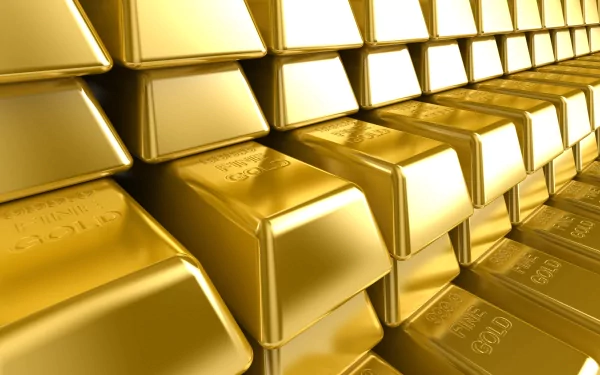 A stunning HD desktop wallpaper featuring a close-up view of stacked gold bars, showcasing the elegance and richness of man-made gold. Perfect backdrop for any screen.