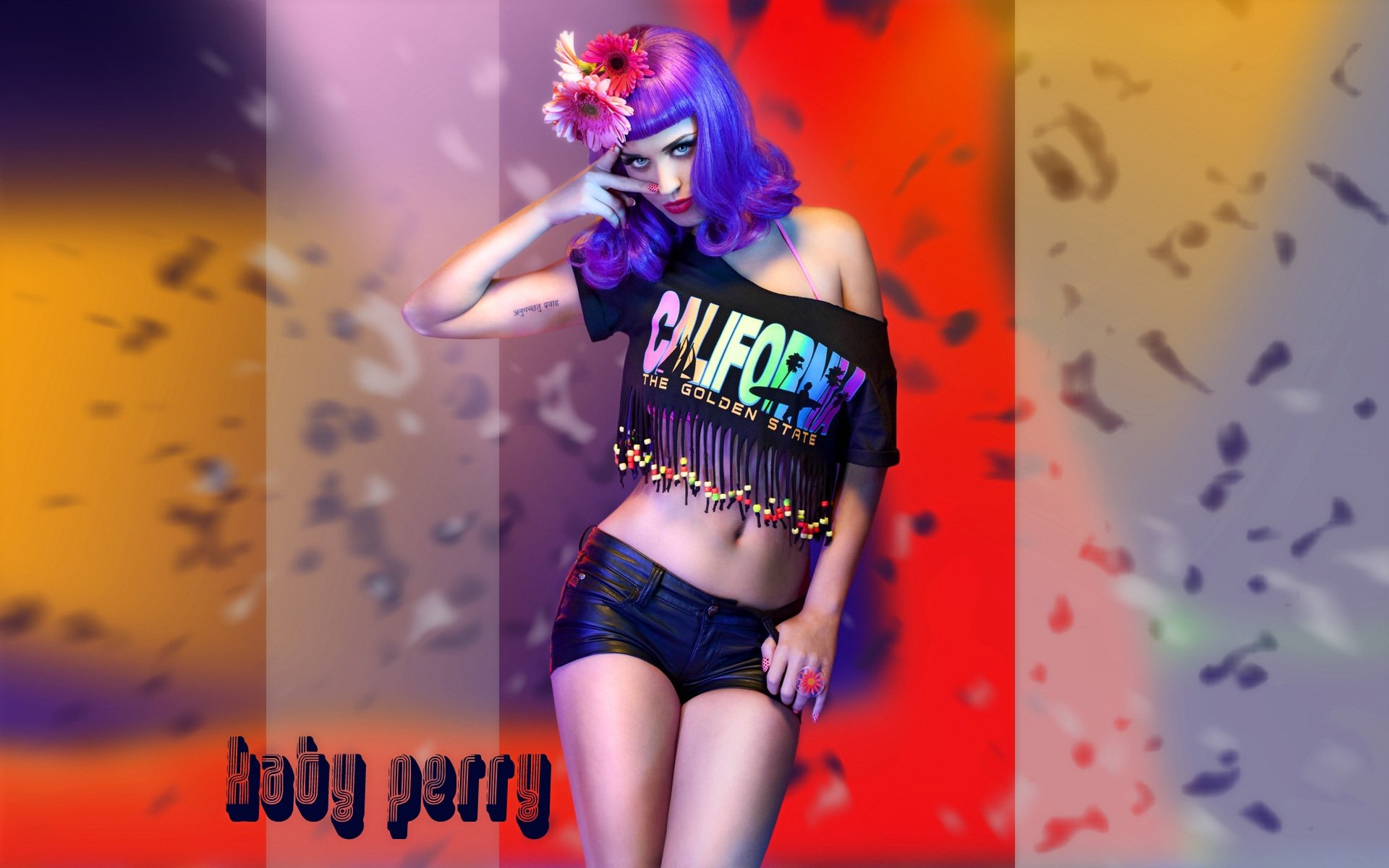 A vibrant HD desktop wallpaper featuring Katy Perry with her signature purple hair, wearing a colorful crop top and shorts, set against a lively background of abstract colors.