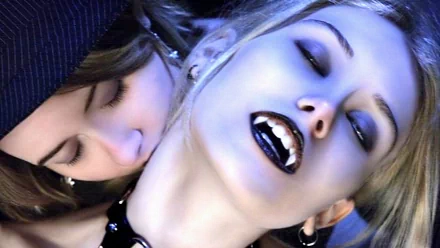 HD desktop wallpaper featuring a beautiful demon and a vampire in a fantasy setting; one figure with fangs exposed, and another biting their neck.