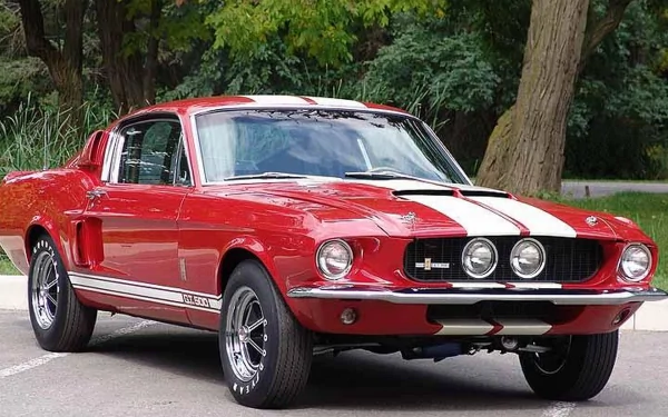 A vibrant red Ford classic muscle car with white racing stripes, captured in 4K Ultra HD as a detailed PC desktop wallpaper background.
